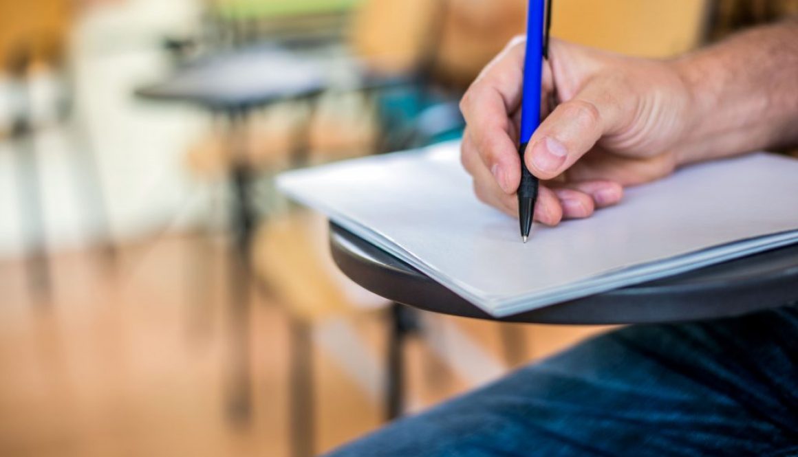 man-is-writing-signing-paper-focused-hand-with-pen