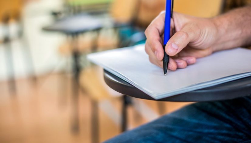 man-is-writing-signing-paper-focused-hand-with-pen
