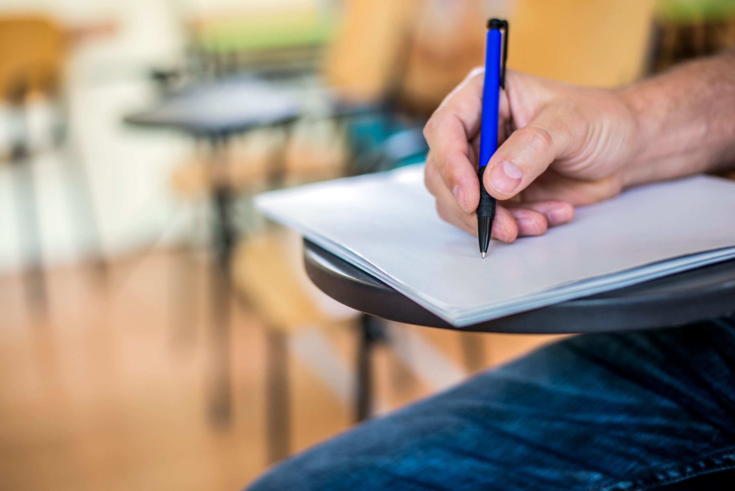 man-is-writing-signing-paper-focused-hand-with-pen